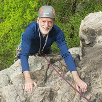 Andrew Bernat climbing a mountain